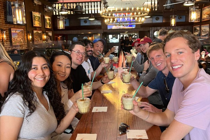 a group of people sitting at a table enjoying a cocktail at El Galleon